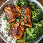 Salmon Broccoli Rice Bowl 11 Top-down view of a salmon broccoli rice bowl with sesame seeds and scallions.