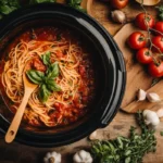 Freshly made Guinea Grinder Sandwich with layers of salami, ham, melted cheese, and veggies, served on a wooden board.